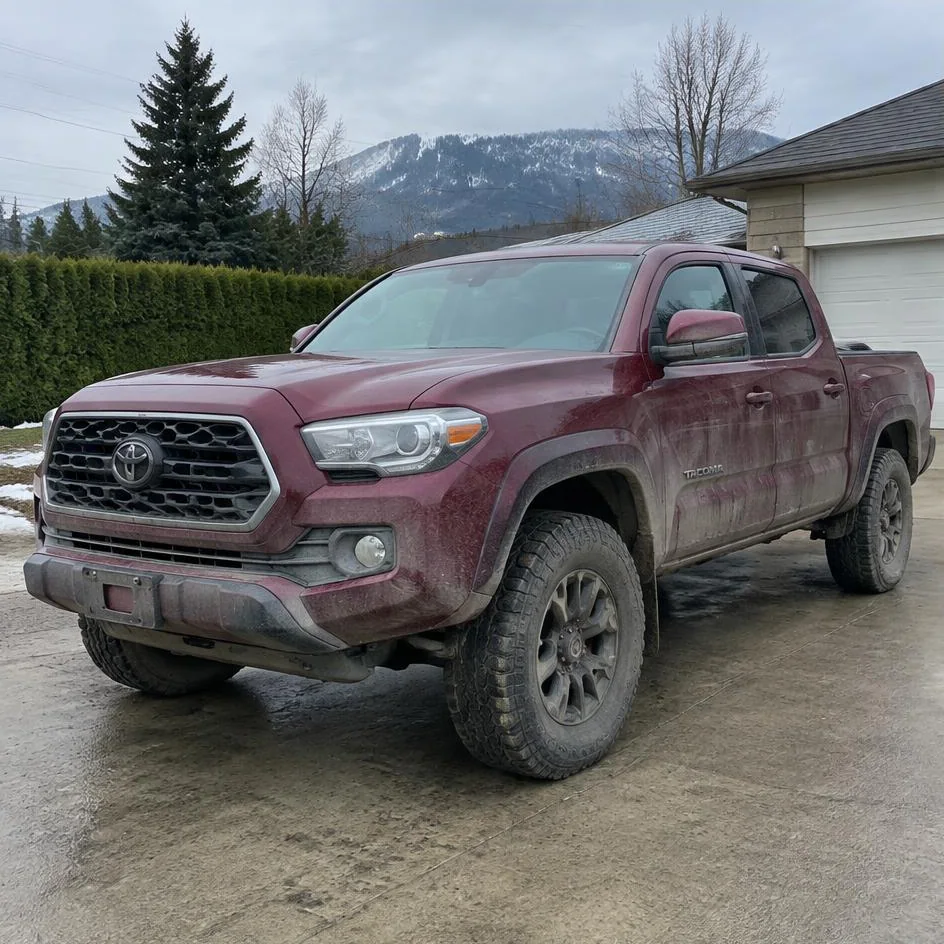 Burgundy Toyota Tacoma before exterior detailing with mud, dust and road buildup in Chilliwack, BC