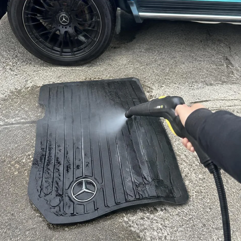 Steam and extraction cleaning a car floor mat at a mobile appointment in Chilliwack, BC