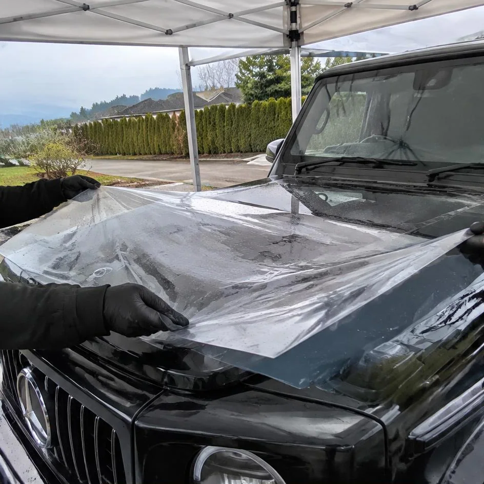 Film positioned with slip solution during paint protection film installation in Chilliwack, BC