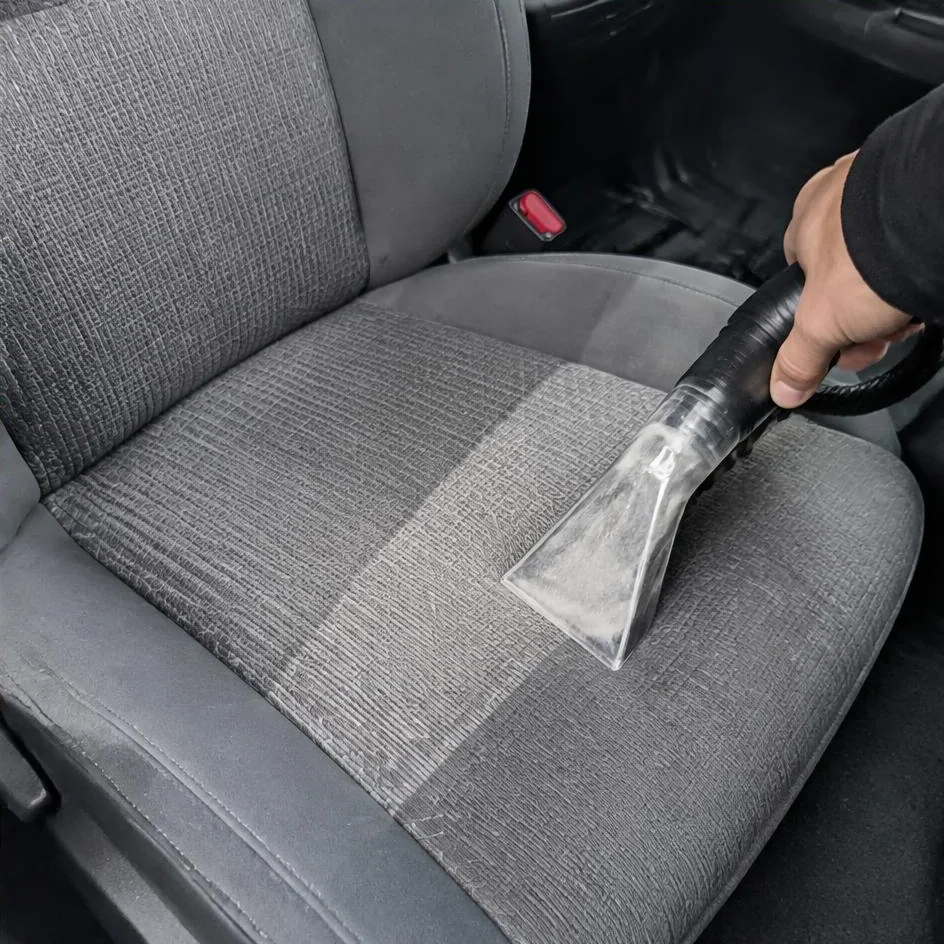 Car seat halfway through hot water extraction showing a clean line in Chilliwack, BC