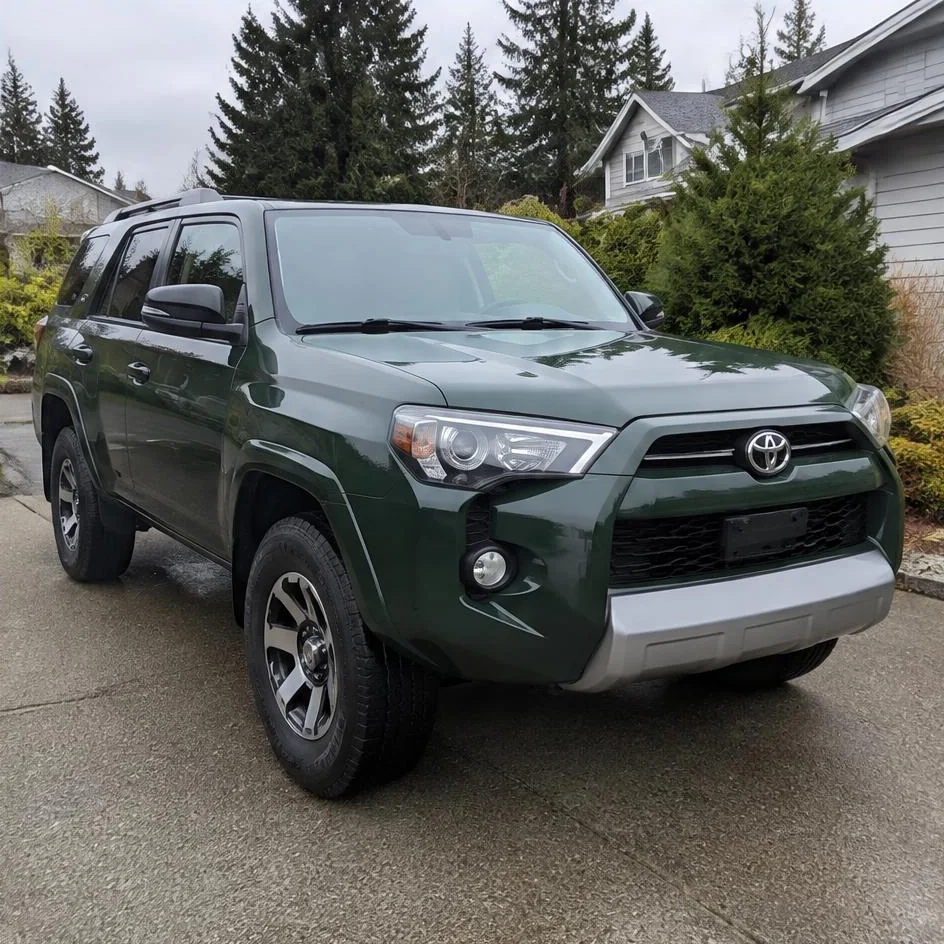 Clean dark green SUV on a residential driveway at the end of a detail in Chilliwack, BC